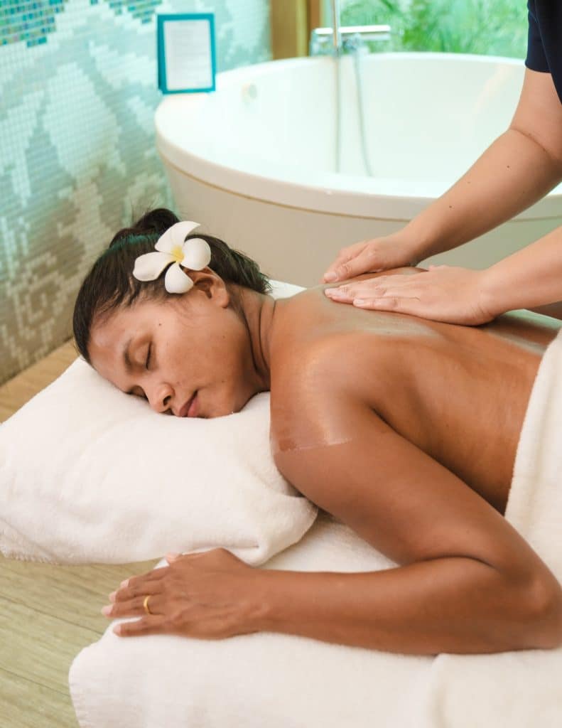 Asian women on a massage table, Asian woman getting a Thai massage at a luxury hotel in Thailand