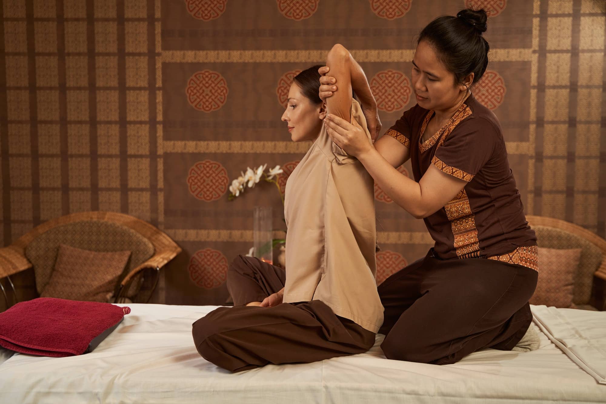Serene spa client getting Thai stretching massage